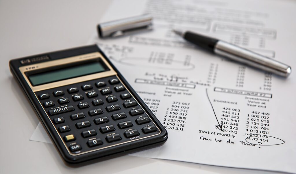 Budgeting documents with a pen and calculator 