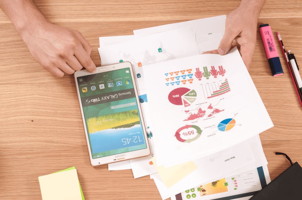 Credit reports with colorful graphs and a mobile phone