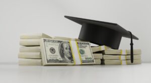 When Do Student Loans Resume? a stack of dollar bills and a graduation hat