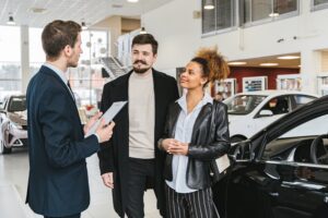 Couple buying car in dealership after securing an atuo car loan
